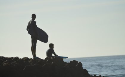 Bodyboarders Watching The Ocean